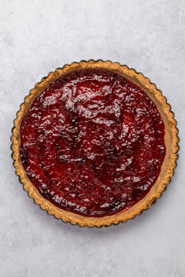 raspberry jam spread over a graham cracker crust.