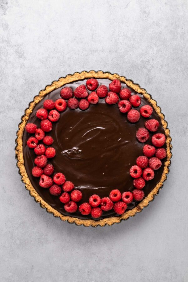 fresh raspberries spread over a chocolate tart.