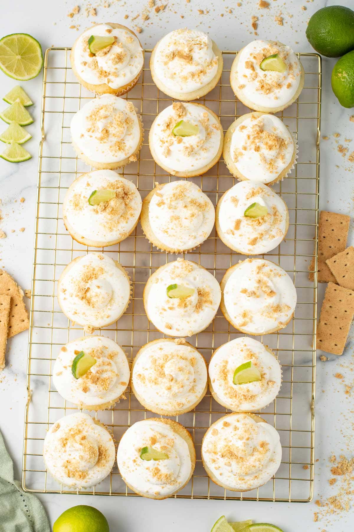 overhead view of key lime pie cupcakes decorated with graham cracker crumbs.