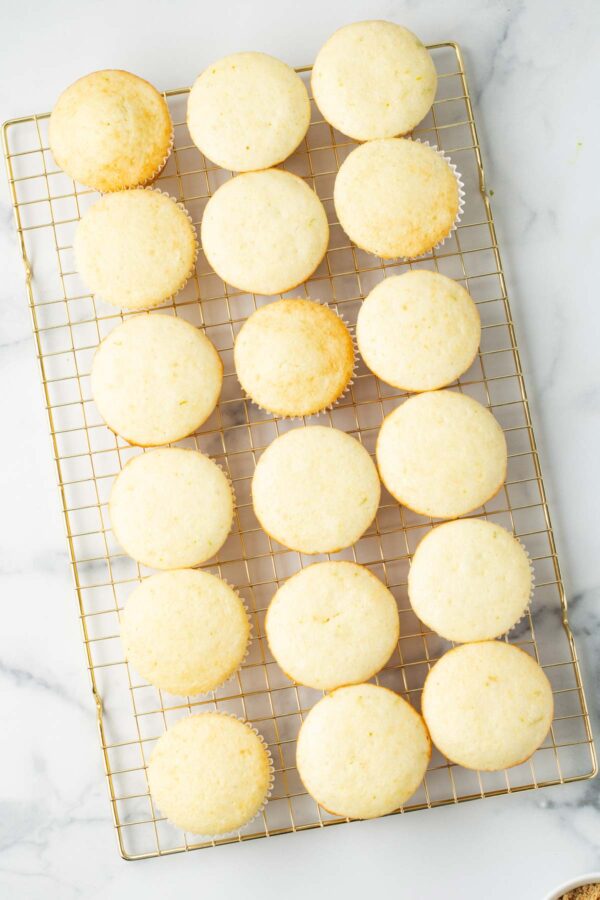 lime cupcakes on a metal cooling rack.