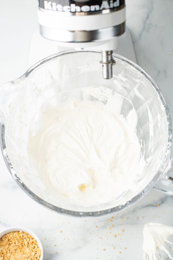 homemade whipped cream cheese frosting in a mixing bowl.