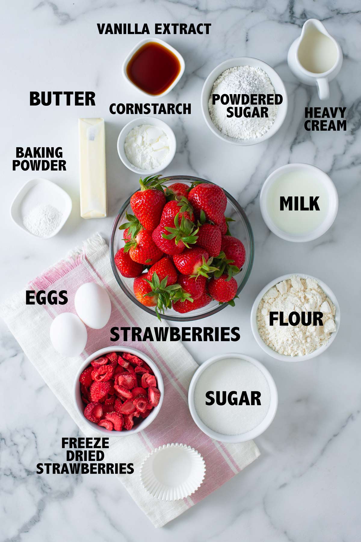 overhead view of ingredients used to make strawberries and cream cupcakes.