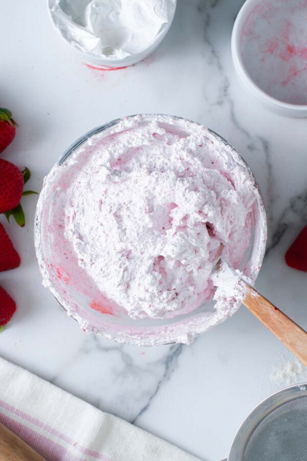 strawberry buttercream frosting in a glass bowl.