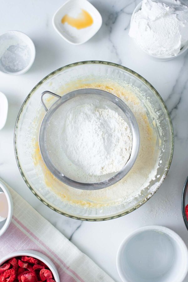 sifting flour into cupcake batter.