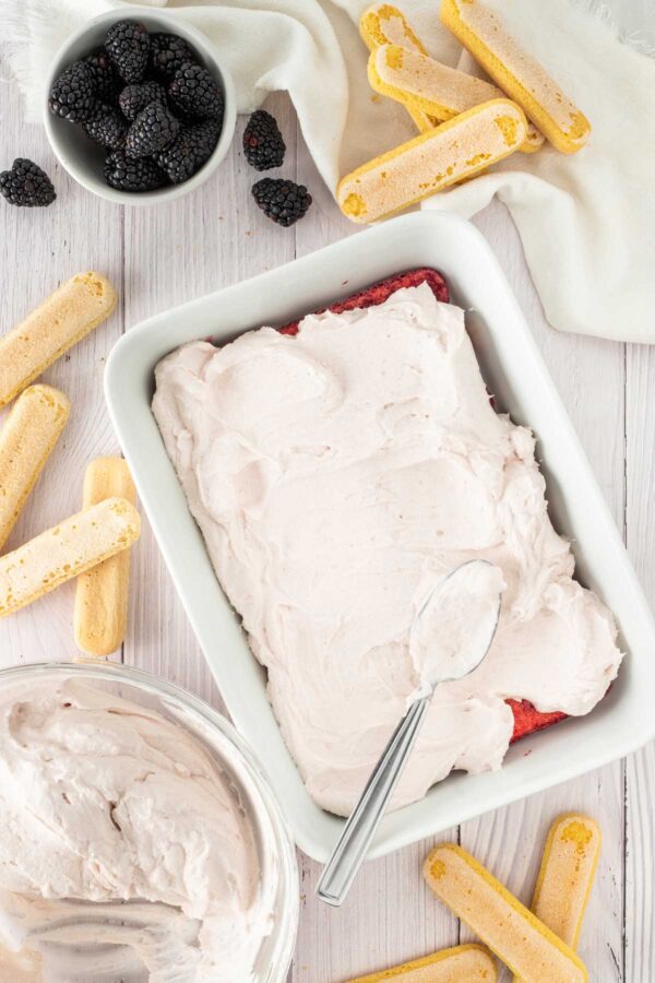 spreading blackberry mascarpone over dipped ladyfingers.
