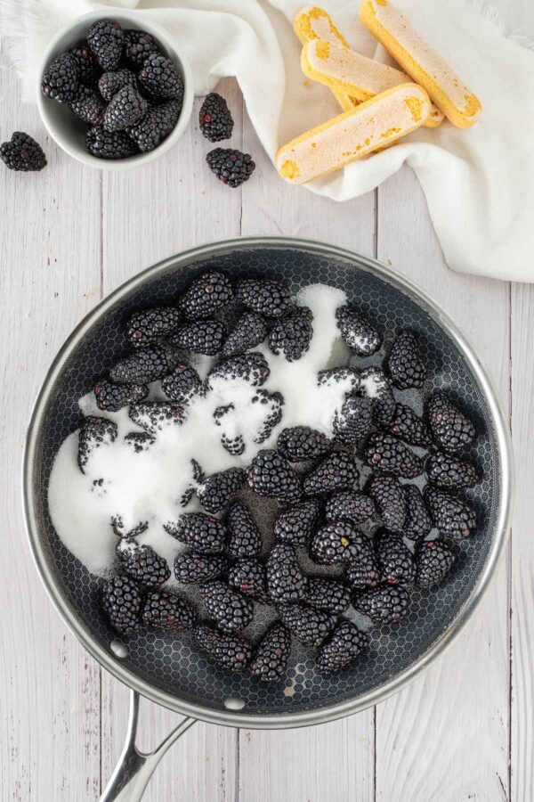 cooking down blackberries and sugar in a saucepan.