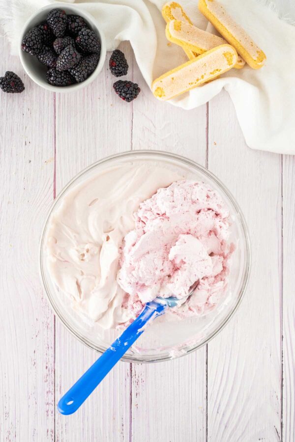 folding whipped cream into blackberry mascarpone.