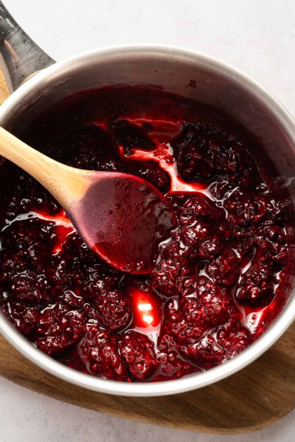 cooking down blackberries and lemon juice in a saucepan.
