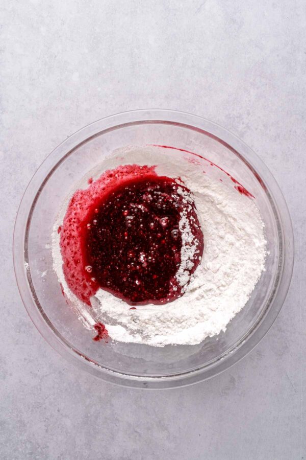 mixing blackberry puree with powdered sugar.
