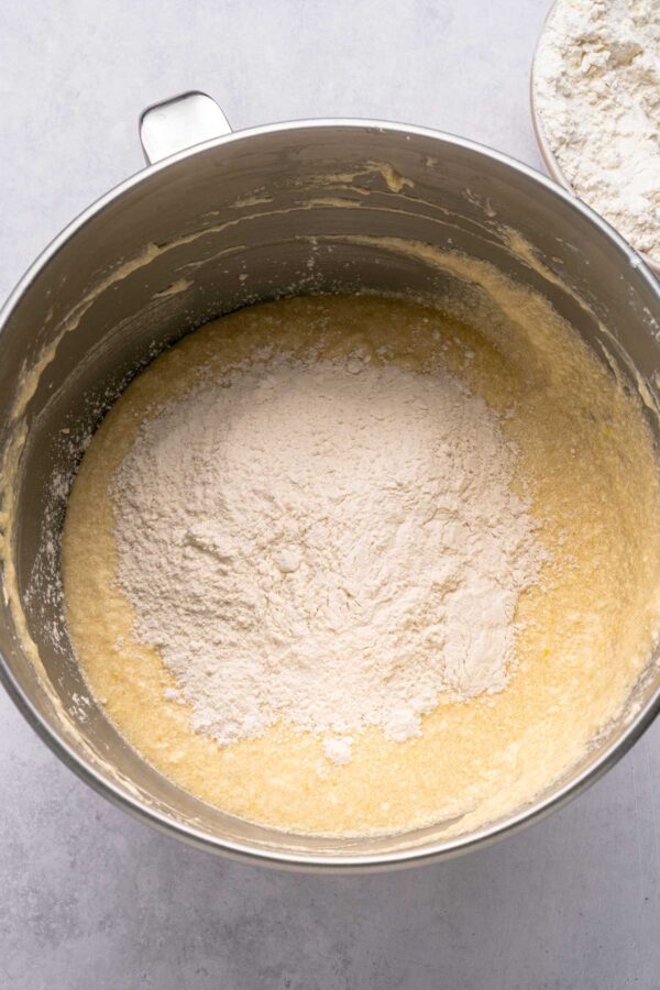 slowly adding dry ingredients to bundt cake batter.