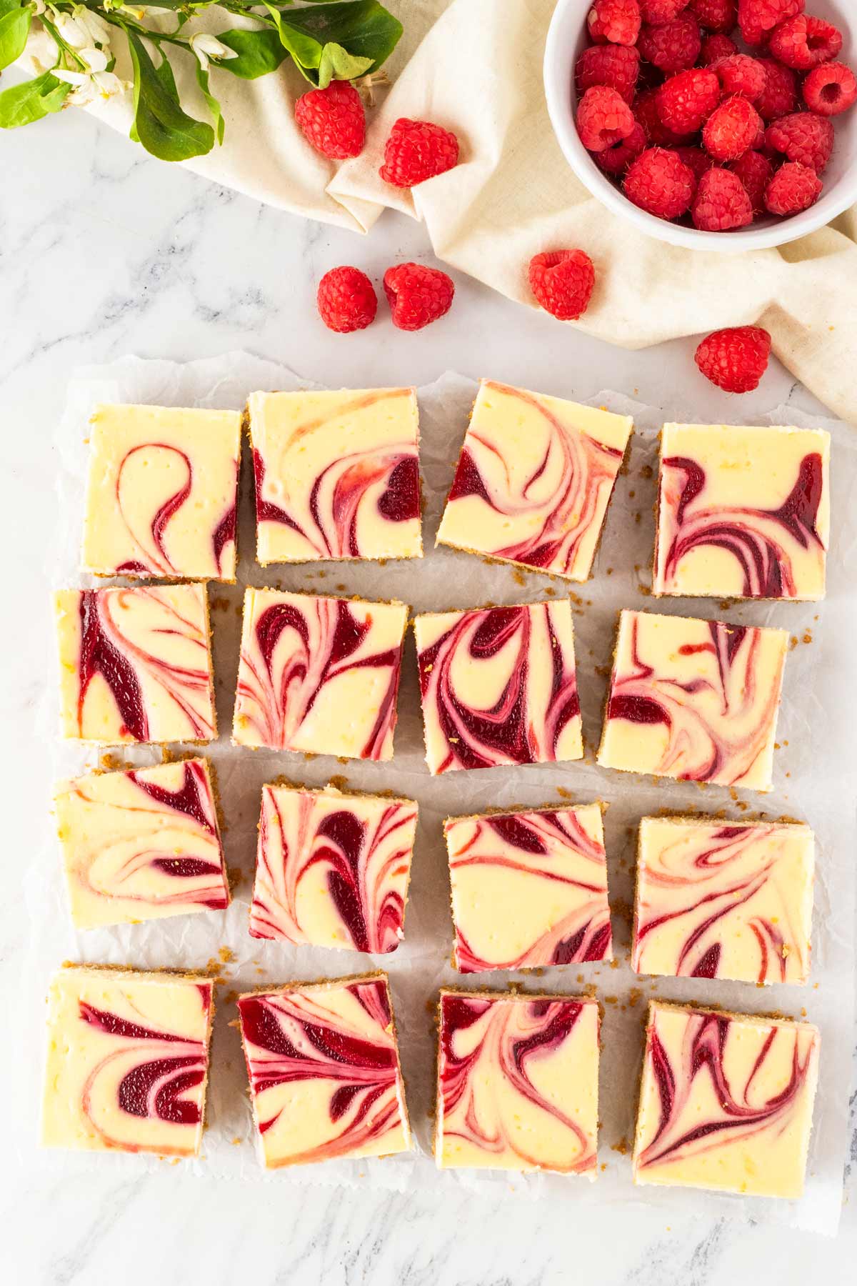 overhead view of cheesecake bars cut into neat squares.
