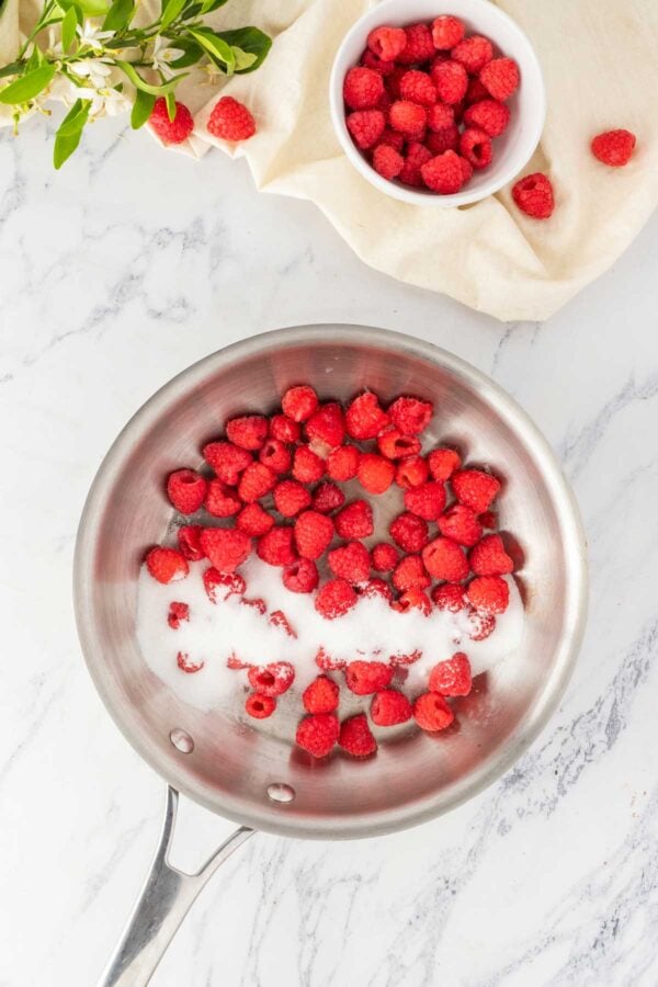 cooking down raspberries with sugar.