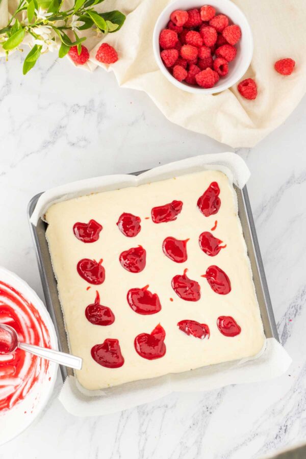 dollops of raspberry sauce on top of the lemon cheesecake filling.