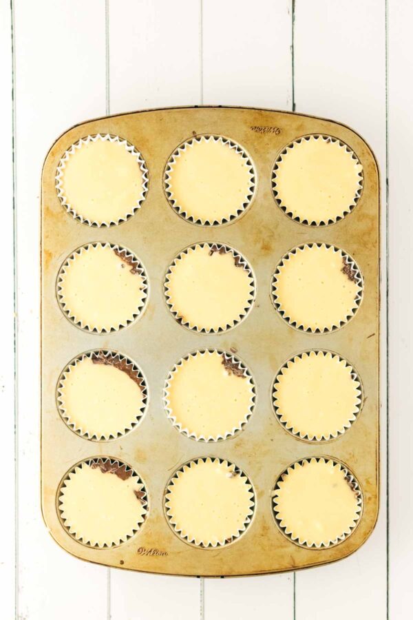 cupcake liners topped with vanilla cake batter.