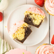 neapolitan cupcakes with chocolate and vanilla cupcake layers and strawberry buttercream.