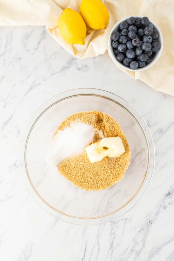 graham crackers, sugar, and butter in a mixing bowl.