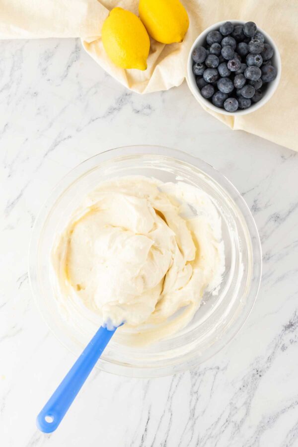 folding whipped heavy cream into cream cheese.