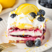 square of layered no bake cheesecake with lemon curd and blueberries.
