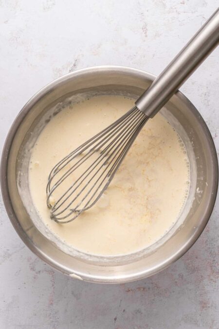 whisking heavy cream, sugar, and vanilla.