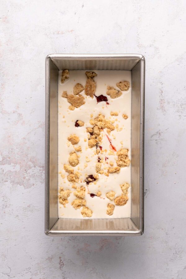 sprinkling homemade shortbread crumble on homemade ice cream.