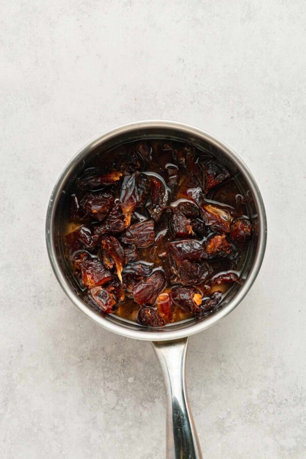 simmering dates and water in a saucepan until soft.