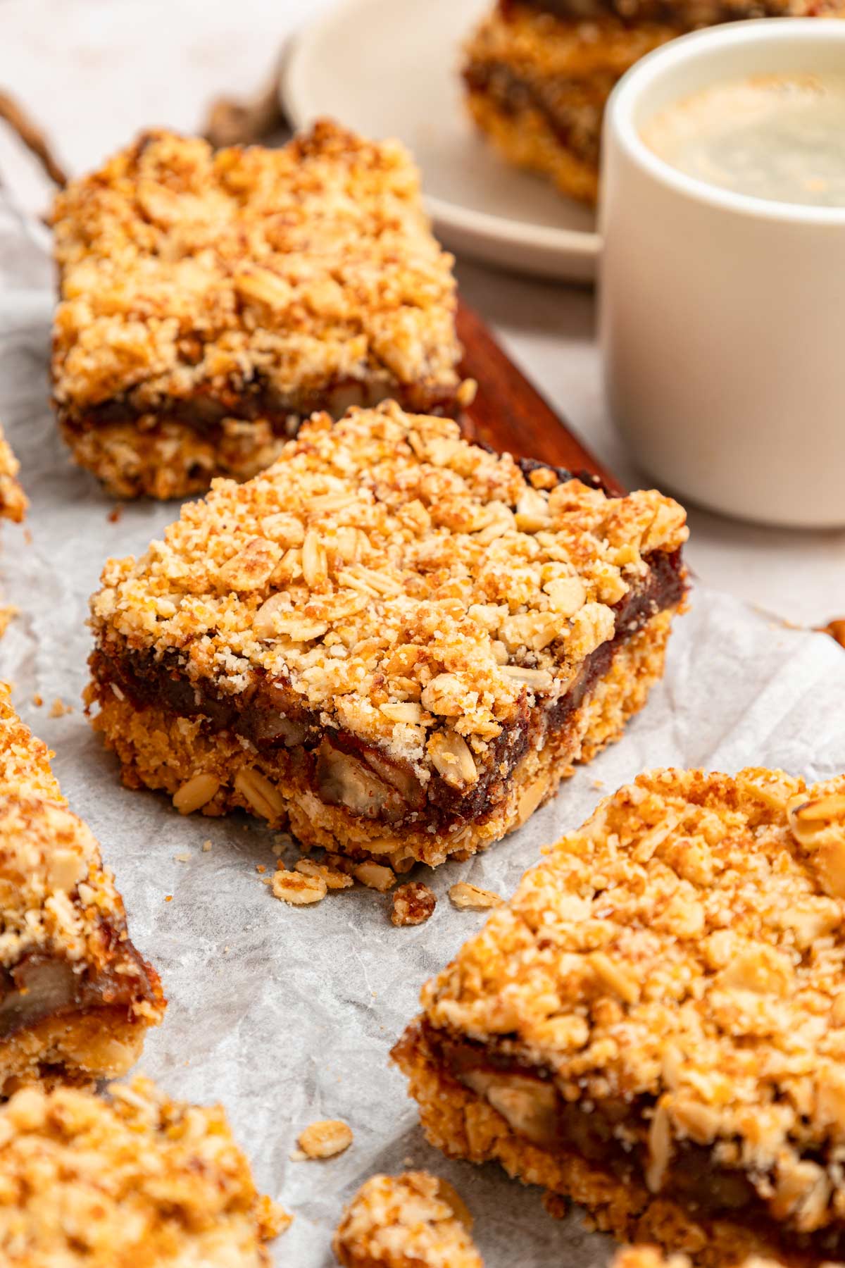 coconut oat date bars on a piece of parchment paper.