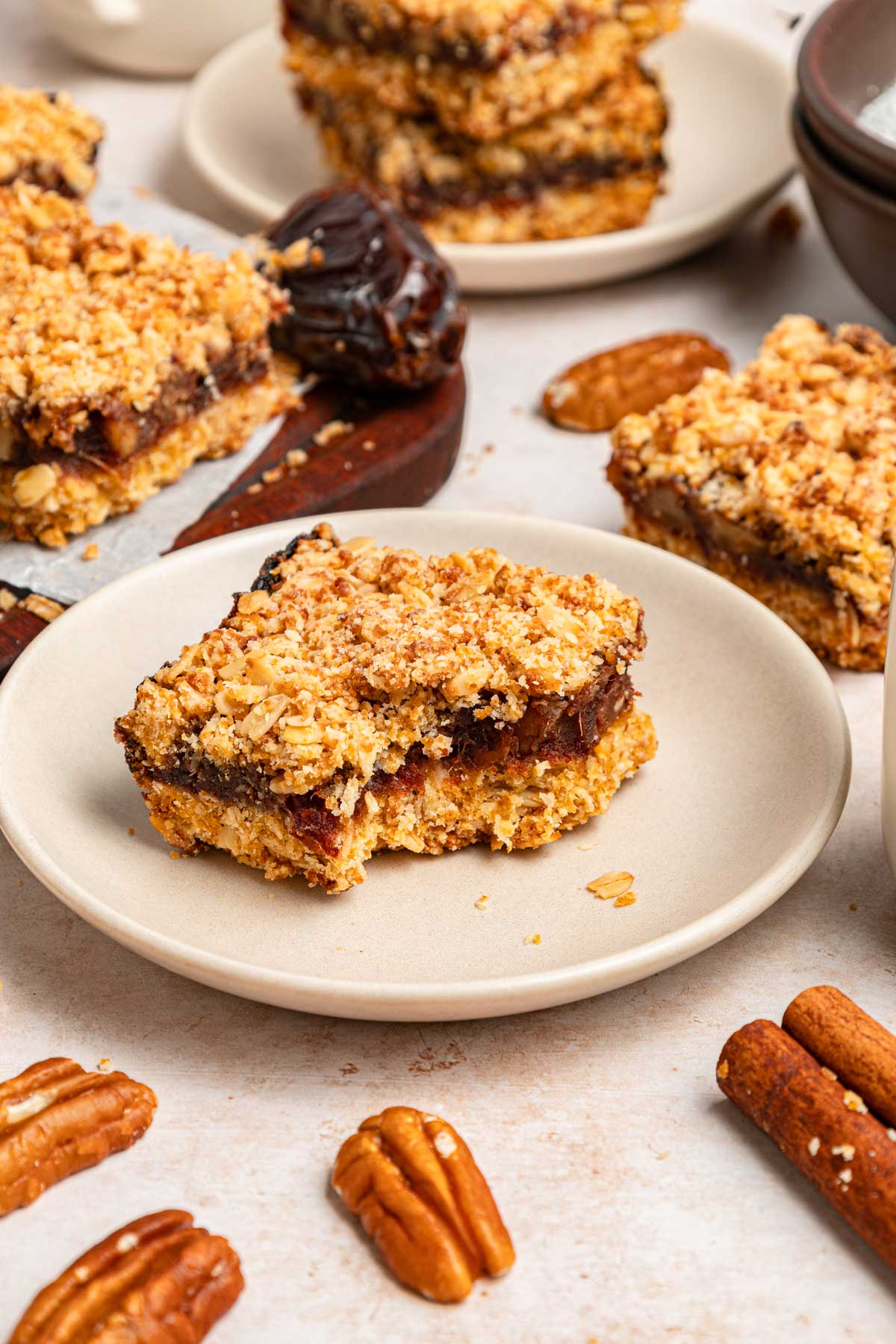 homemade date bar on a small plate with one bite taken.