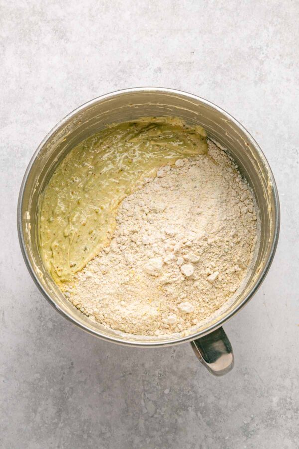 adding almond flour to pistachio cake batter.