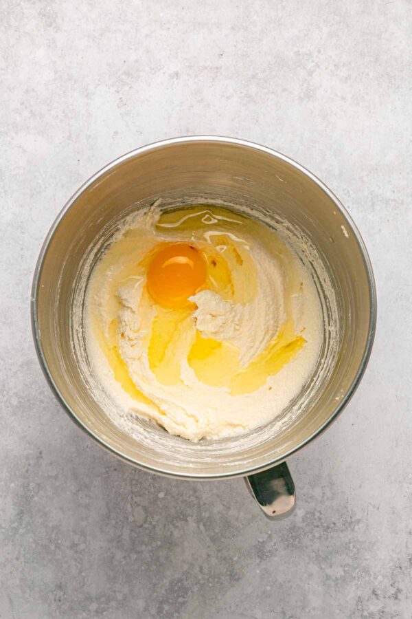 adding eggs and sour cream to creamed butter and sugar.