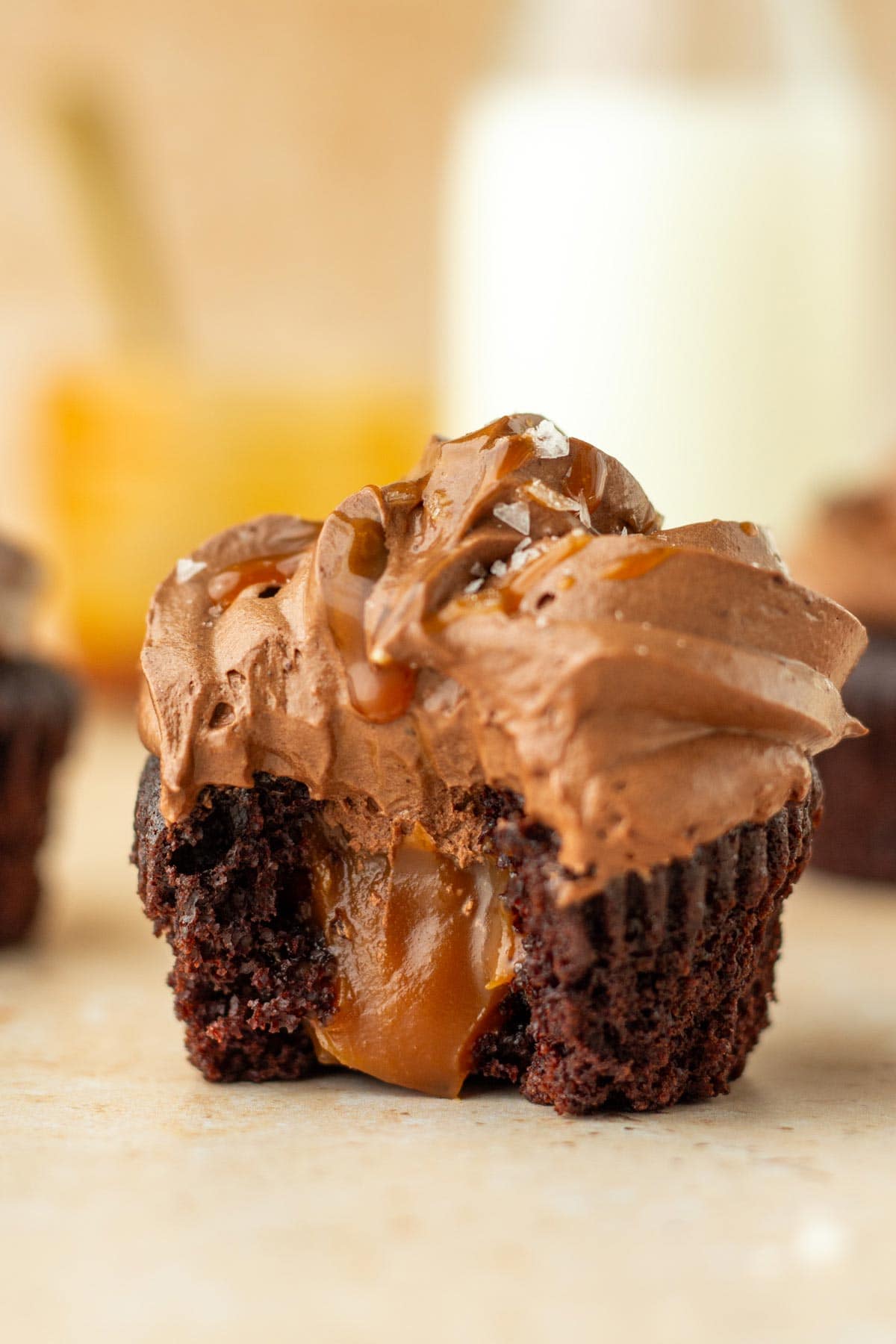 chocolate cupcake cut in half showing the inside filled with caramel.