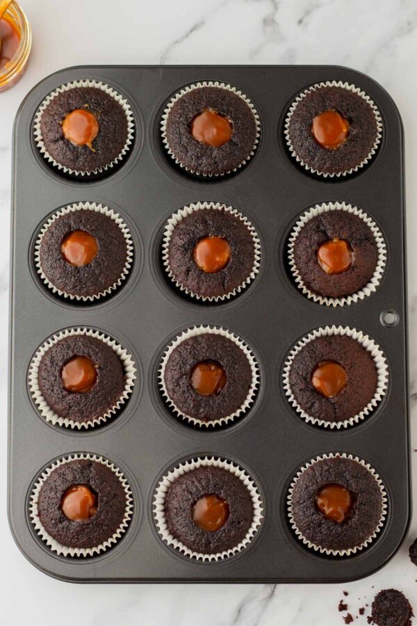 overhead view of cupcakes cored and filled with salted caramel.