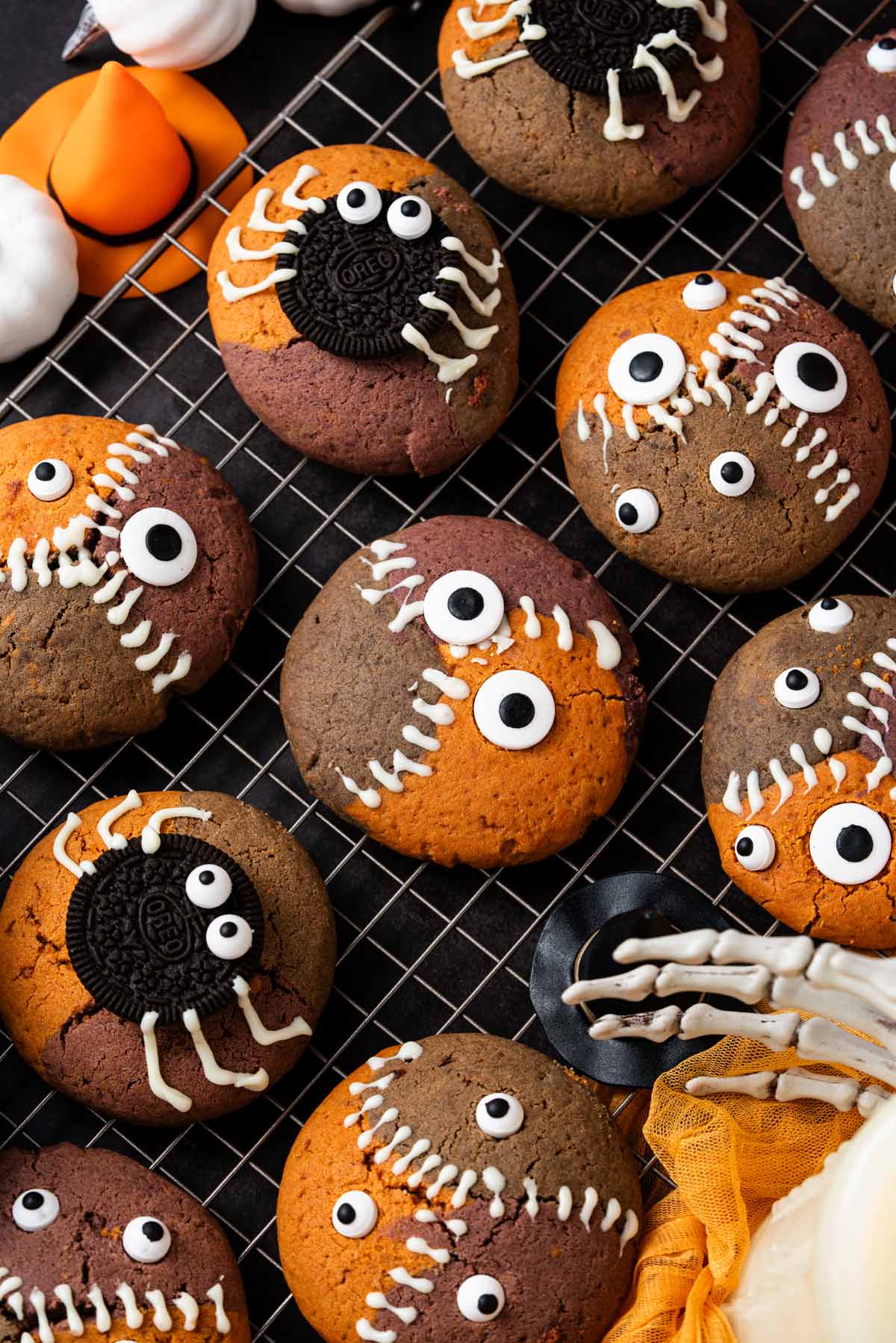 decorated monster and spider cookies on a wire cooling rack.