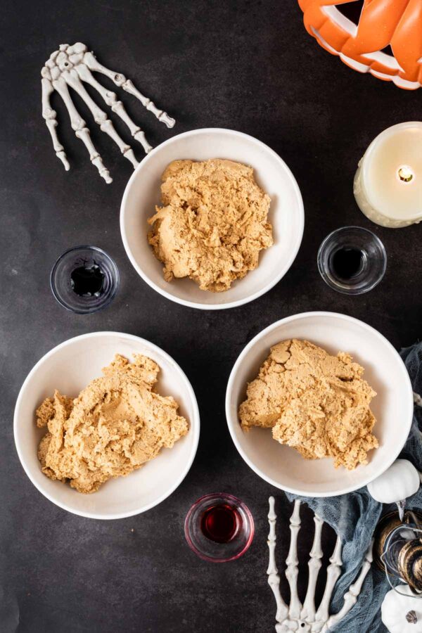 cookie dough divided into three bowls.