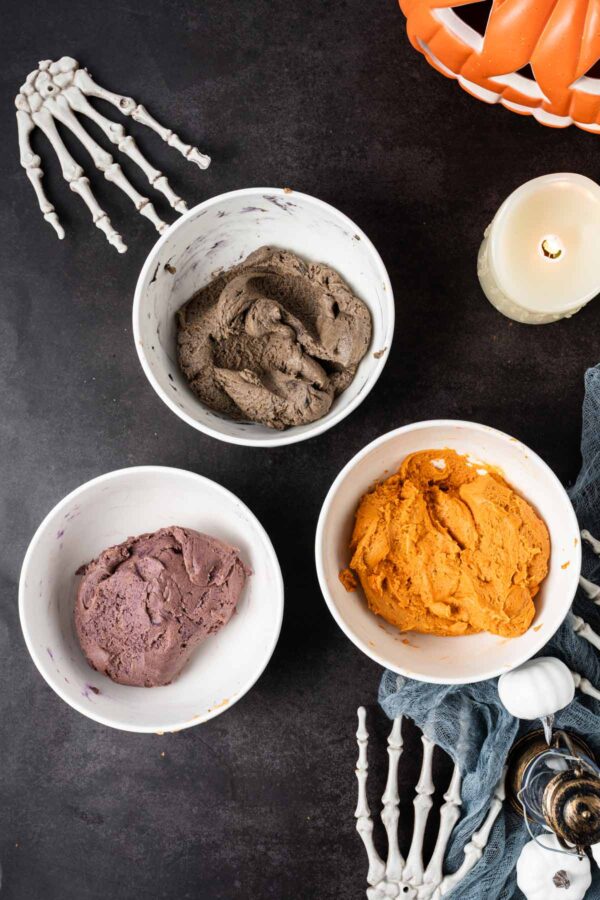 cookie dough tinted with food coloring to black, purple, and orange.