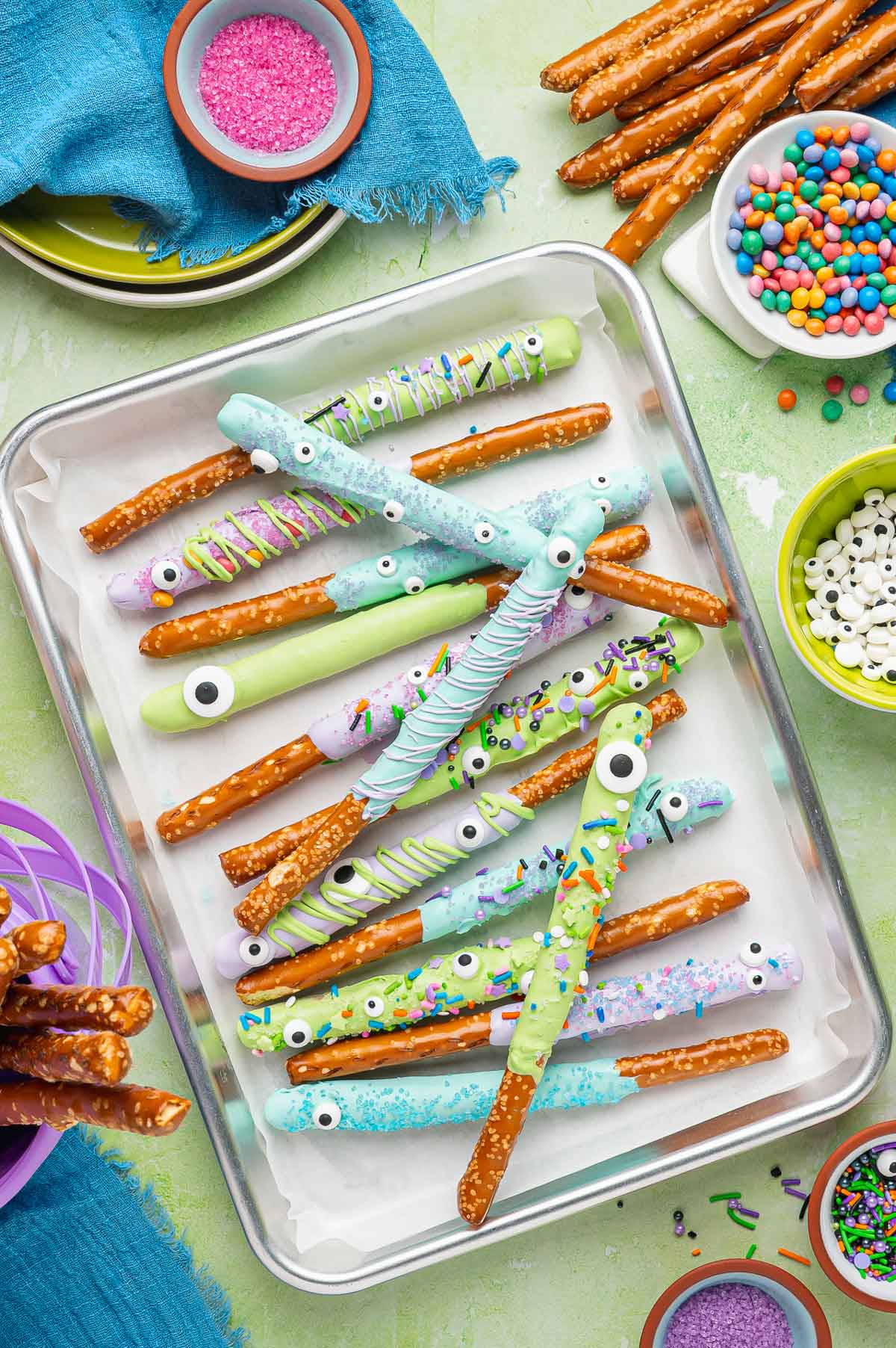 pretzel rods dipped in chocolate and decorated for halloween.