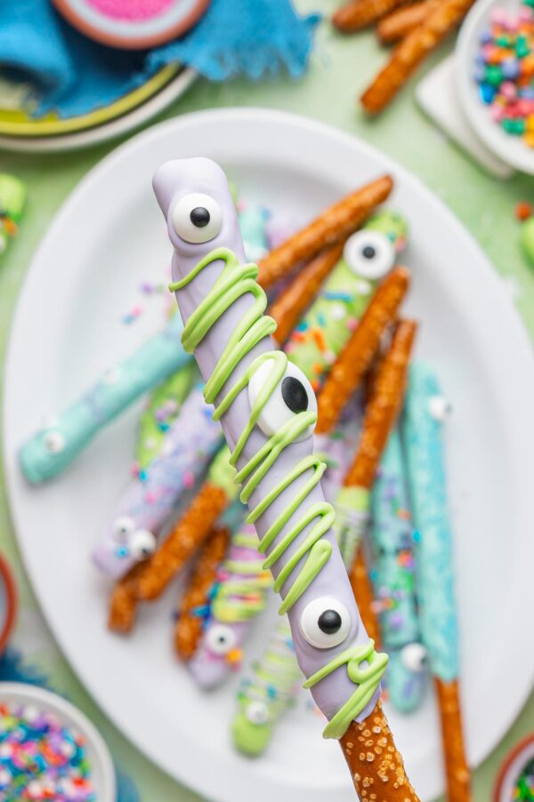 monster pretzel rod decorated with giant eyeballs and chocolate drizzle.