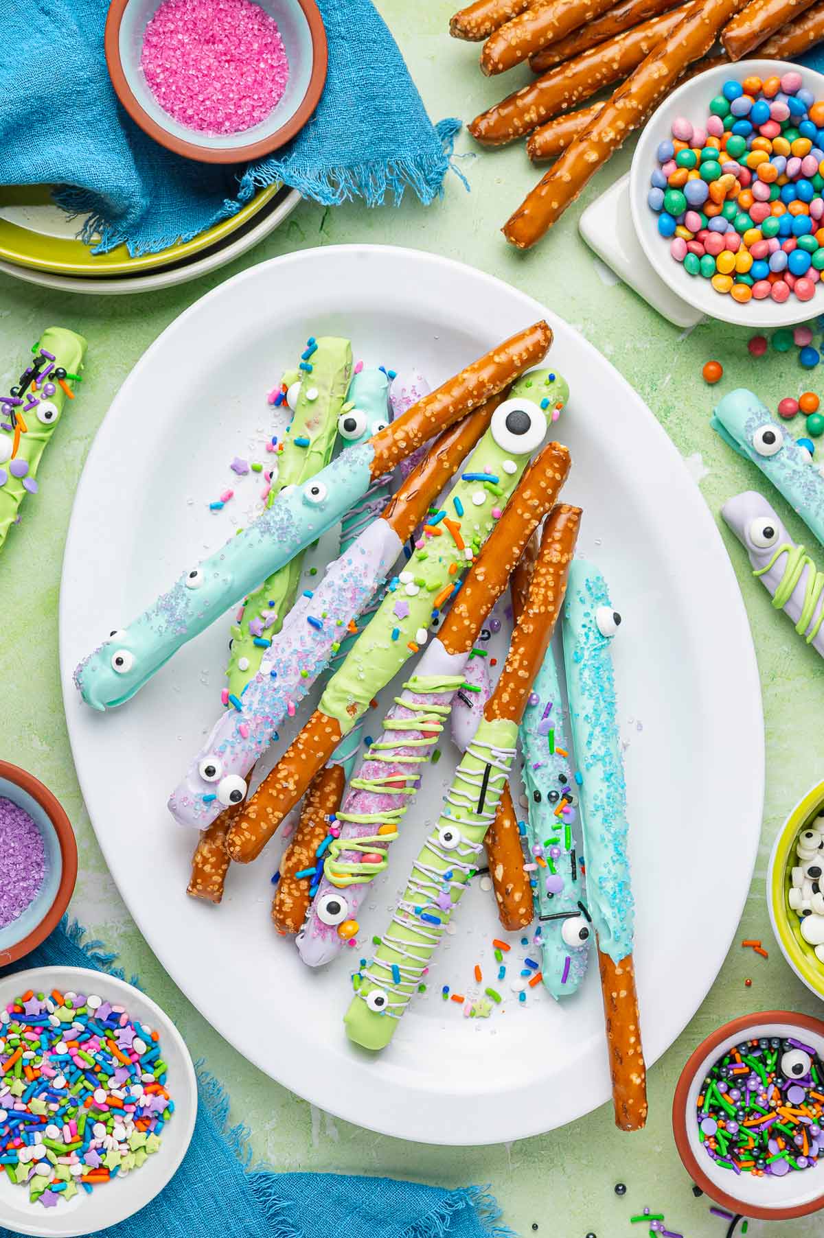 decorated monster pretzel rods covered with candy eyes and sprinkles.
