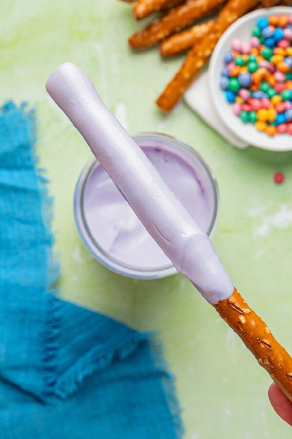 pretzel rod covered in melted purple candy wafers.