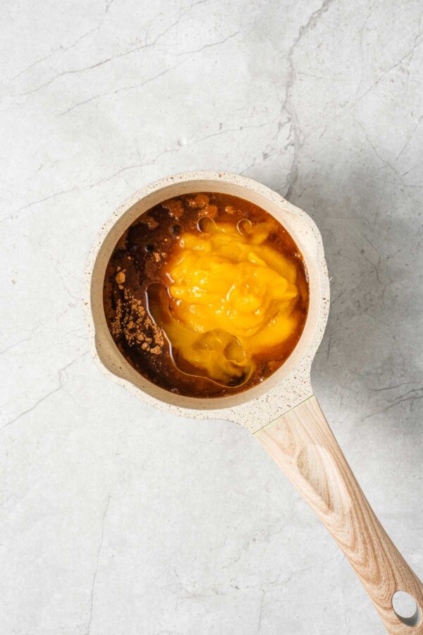 small saucepan filled with ingredients for homemade pumpkin butter.