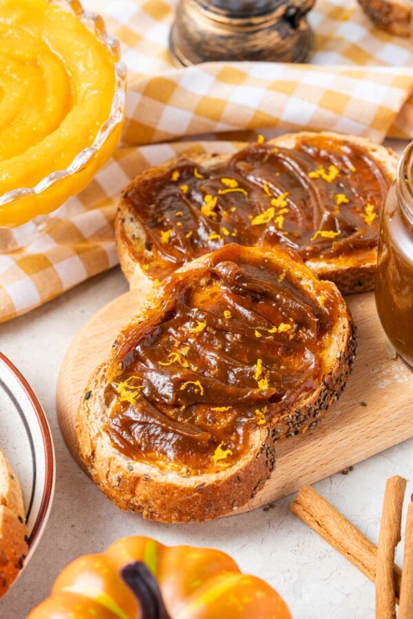 two pieces of toast spread with a thick layer of homemade pumpkin butter.