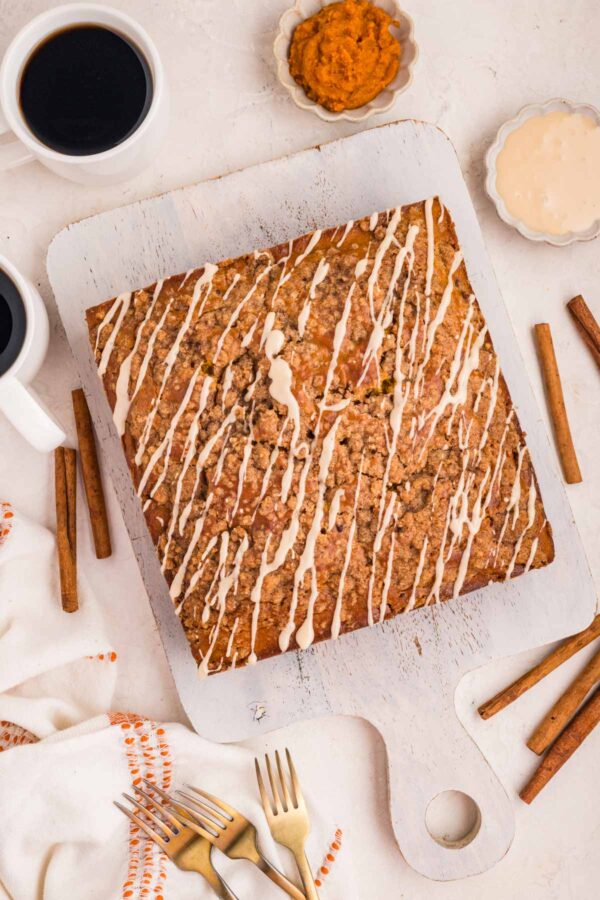 uncut pumpkin coffee cake covered with maple drizzle.