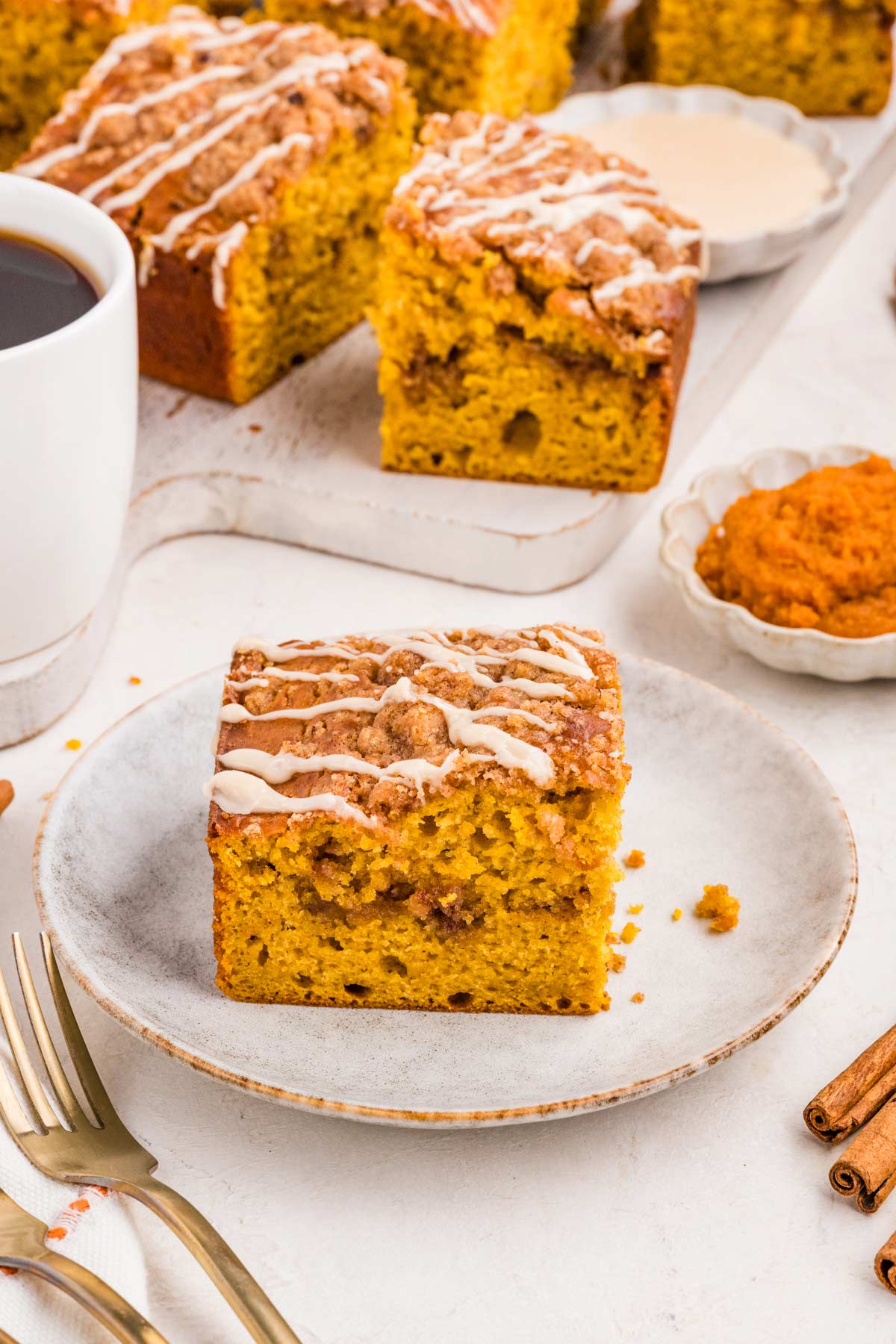 side view of a slice of coffee cake with a cinnamon ribbon running through the middle.