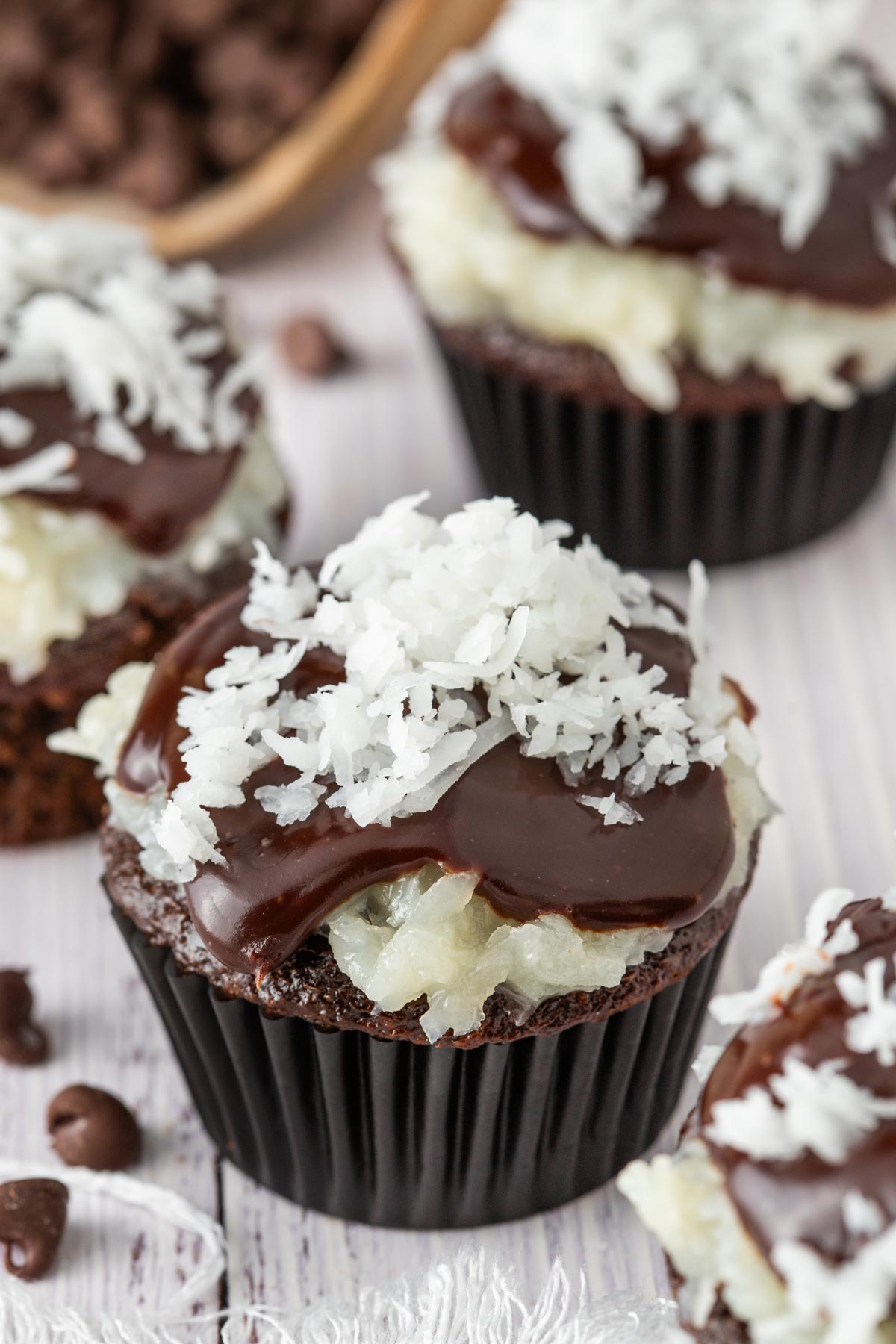 chocolate cupcakes topped with coconut and ganache.
